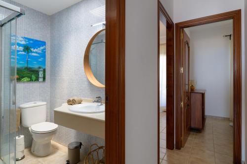 a bathroom with a toilet and a sink and a mirror at Mariate II Descanso y vistas al Mar in Punta de Mujeres