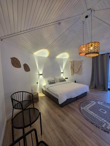 a bedroom with a bed and a table and chairs at nature village olympos in Kumluca