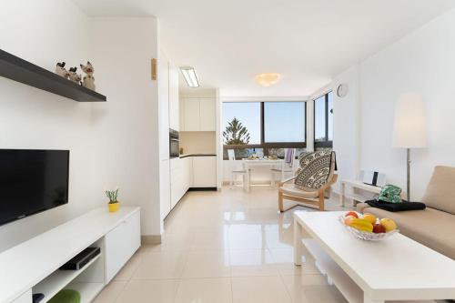 a large white living room with a couch and a table at Ocean View Playa del Aguila in Playa del Aguila