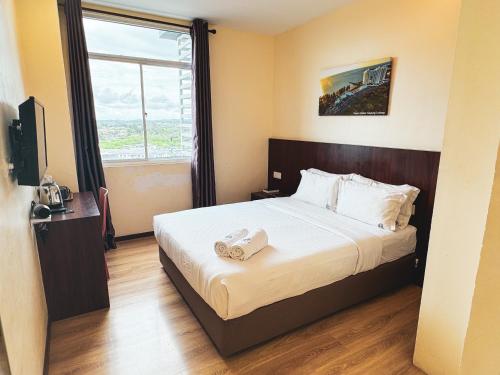 Postel nebo postele na pokoji v ubytování Emart Hotel (Riam)