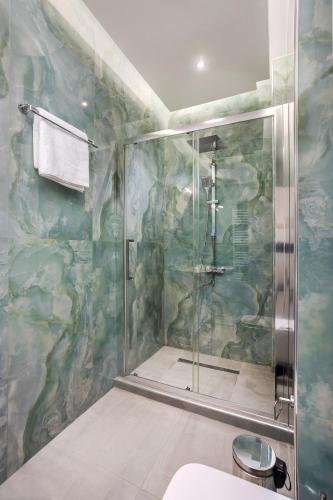 a shower with a glass door in a bathroom at Adorable Modern Guesthouse 2 in Perea