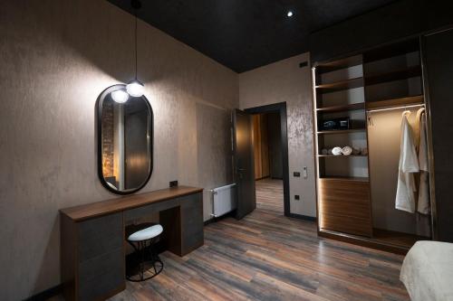 a bedroom with a vanity and a mirror and a bed at Luxury Beachfront Villa with Indoor Pool & BBQ in Baku