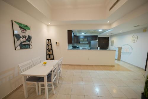 a kitchen and dining room with a table and chairs at Yogi - 2BR Churchill - Floor 52 & Burj View in Dubai