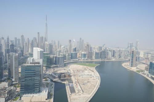 an aerial view of a city with a river at Yogi - 2BR Churchill - Floor 52 & Burj View in Dubai