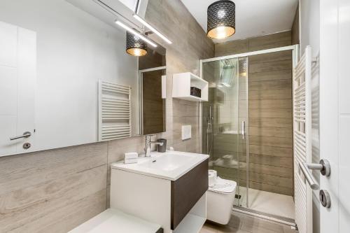 a bathroom with a sink and a toilet and a shower at Secret Of Lugano With Lake View - Happy Rentals in Aldesago