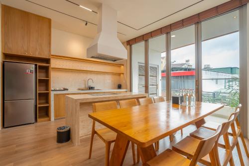 a kitchen and dining room with a wooden table and chairs at Colline Dalat in Da Lat