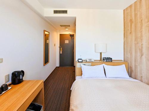 Ένα ή περισσότερα κρεβάτια σε δωμάτιο στο Park Hotel Kani