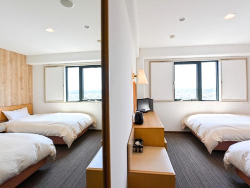 Ένα ή περισσότερα κρεβάτια σε δωμάτιο στο Park Hotel Kani