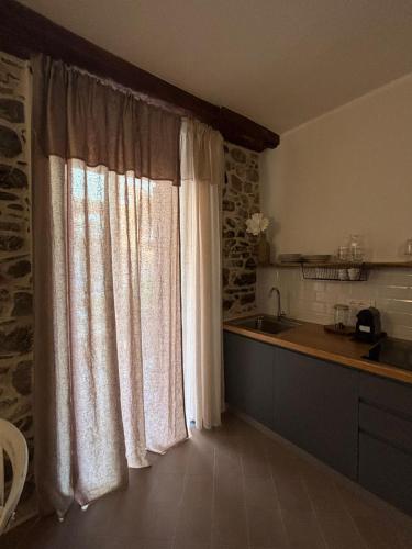 a kitchen with a large window and a sink at HH Moneglia la Piazzetta in Moneglia