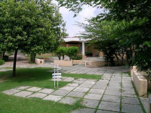 a garden with a white cross in the grass at The Meadows Resort and Spa in Aurangabad