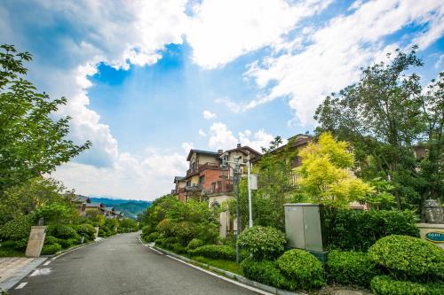 an empty street with houses and trees on a cloudy day at Avatar Valley Villas in Zhangjiajie