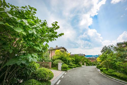 an empty street with trees and houses on a cloudy day at Avatar Valley Villas in Zhangjiajie