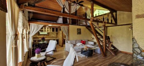 a living room with a staircase in a house at Mystically Wood House in The Forest in Cîrjari