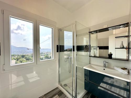 une salle de bain avec une douche et un lavabo et une fenêtre dans l'établissement Villa Pessicart, à Nice