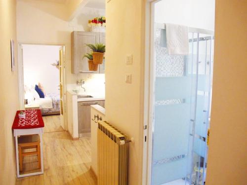 a small bathroom with a shower and a sink at Blue House Termini-Colosseo in Rome