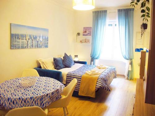 a bedroom with a bed and a couch in it at Blue House Termini-Colosseo in Rome