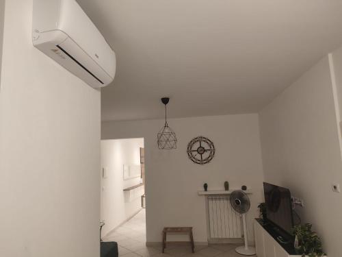 a white room with a clock on the wall at Casa André in Imola