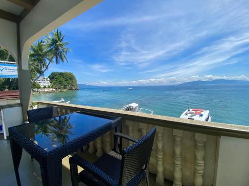 a balcony with a view of the ocean at Lalaguna Villas Luxury Dive Resort and Spa in Puerto Galera