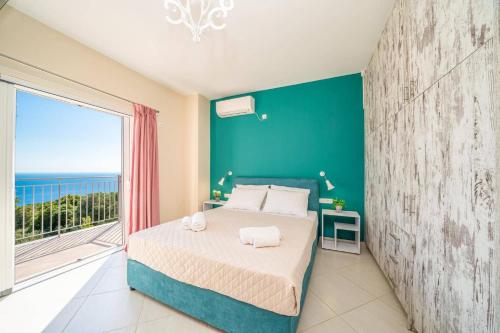 a bedroom with a bed and a large window at Villa Roz by Villa Plus in Plateies