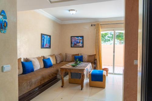 a living room with a couch and a table at Luxury Villa Ocean View with pool in Tiguert