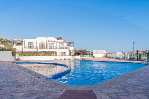 a large swimming pool in front of a building at Luxury Villa Ocean View with pool in Tiguert