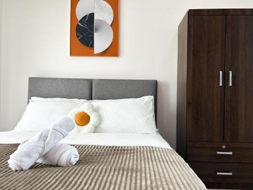 a bedroom with a bed with a stuffed animal on it at Tulip Residences by Manhattan Group in Shah Alam