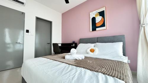 a bedroom with a bed with two towels on it at Tulip Residences by Manhattan Group in Shah Alam