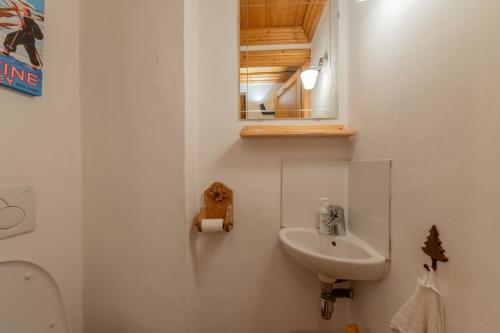 a bathroom with a sink and a mirror and a toilet at Lodge 4 Apartment 9- Snow and Trek - Morzine in Montriond