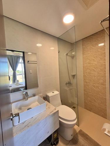 a bathroom with a toilet and a sink and a shower at Twin AJ Boracay in Boracay