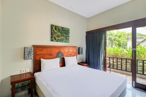 Postel nebo postele na pokoji v ubytování Collection O Bali near Sanur Beach formerly Akarsa Kokoro