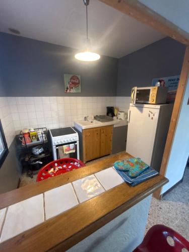 a small kitchen with a counter and a refrigerator at Appartement centre historique in Beaucaire