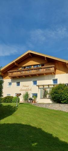 a large building with a lawn in front of it at Haus Sonnblick in Wangle