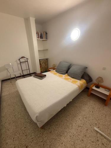 a bedroom with a large bed in a room at Appartement centre historique in Beaucaire