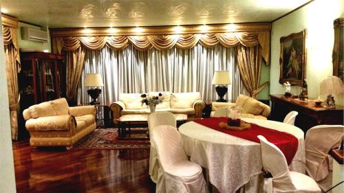 a large living room with a table and chairs at Villa Habana in Fonte Nuova