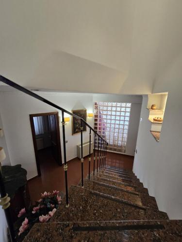 a stairway in a home with a spiral staircase at Villa Habana in Fonte Nuova