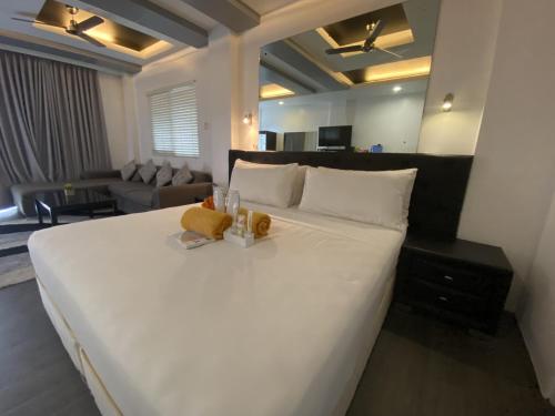 a large white bed in a hotel room at Lalaguna Villas Luxury Dive Resort and Spa in Puerto Galera