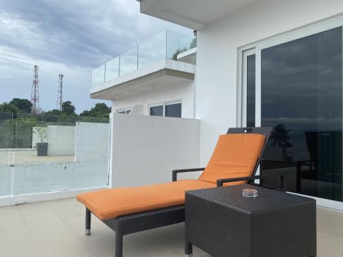 an orange chair sitting on top of a balcony at Lalaguna Villas Luxury Dive Resort and Spa in Puerto Galera