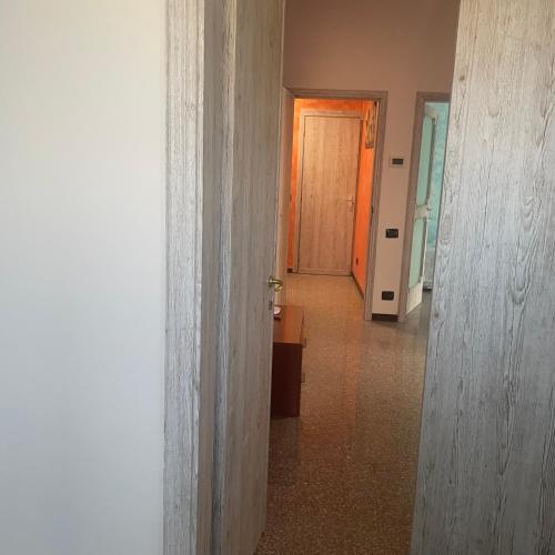 an empty hallway with a wooden door and a hallway at Madonna dell'ancora in Sassuolo