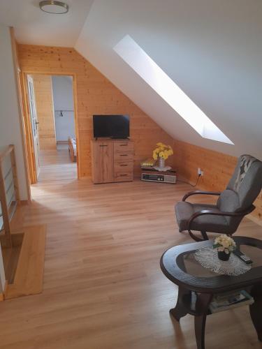 a living room with two chairs and a television at Agroturystyka nad Brusieńką in Cieszanów