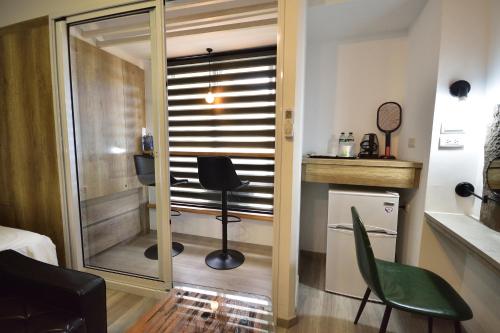 a room with a mirror and a chair and a table at 知本溫泉-彩溱旅宿 in Wenquan