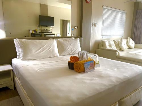 a large white bed with a box on top of it at Lalaguna Villas Luxury Dive Resort and Spa in Puerto Galera