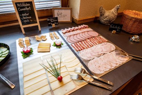 a table with different types of meats and cheese at Pension Schneerose - Wildschönau - PREMIUM CARD im Sommer in Wildschönau