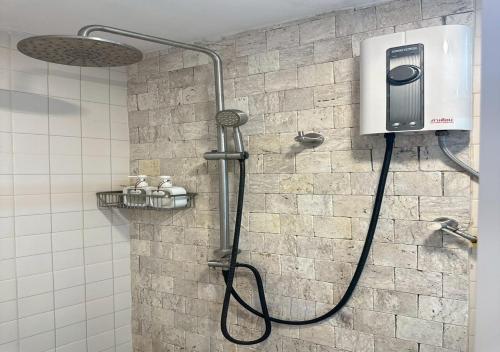 a bathroom with a shower with a dispenser on the wall at Taara Montana Resort in Ban Huai Khai