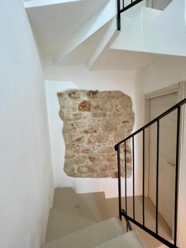 a staircase in a house with a stone wall at Monte Longu in Baunei
