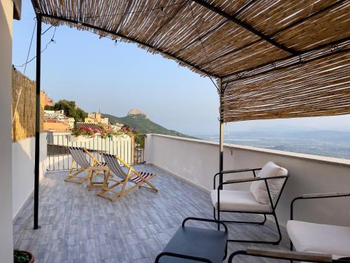 a balcony with chairs and a view of the ocean at Monte Longu in Baunei