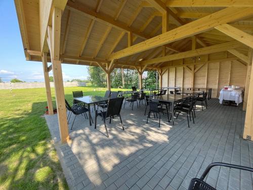 a pavilion with tables and chairs on a patio at Noclegi u Eli Zator Energylandia in Zator