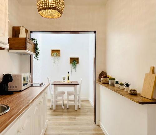 a kitchen with a table and a dining room at Canaryislandshost l Olympica in Teguise