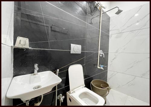 a white bathroom with a sink and a toilet at HOTEL G- RESIDENCY Near Shri Mahakaleshwar Jyotirlinga Temple - Railway Station Ujjian - Fully Air Conditioned And Spacious Room - Excellent Service Recommended in Ujjain