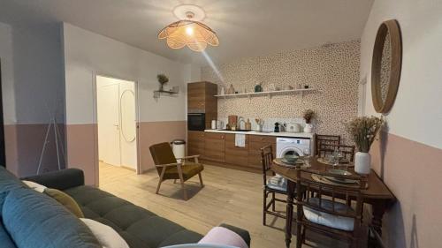 a living room and kitchen with a couch and a table at Quiet and central, 6p fully equipped in Arras