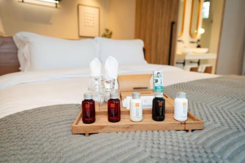 a tray with four bottles of medicine on a bed at Mahutsachan Khlong Thom in Krabi town